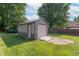 View of a new backyard shed with ample storage space and garage door in a grassy yard at 425 Saddle Hill Ct, Indianapolis, IN 46234