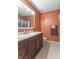 Bathroom featuring a dark vanity, light tile floors, and good lighting from above at 425 Saddle Hill Ct, Indianapolis, IN 46234