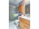 Bathroom featuring a glass shower door, a wood vanity, and modern fixtures at 425 Saddle Hill Ct, Indianapolis, IN 46234