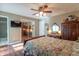 Bedroom featuring a large mirror sliding door closet, hardwood floors, and ample natural light at 425 Saddle Hill Ct, Indianapolis, IN 46234