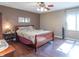 Comfortable bedroom with hardwood floors, a ceiling fan, and a large window at 425 Saddle Hill Ct, Indianapolis, IN 46234
