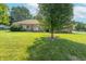 A well-maintained ranch-style home with a spacious front lawn and mature trees at 425 Saddle Hill Ct, Indianapolis, IN 46234