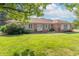 Charming brick home featuring a well-manicured lawn, bright windows, and a welcoming front entrance at 425 Saddle Hill Ct, Indianapolis, IN 46234