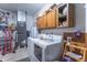 This laundry room features a modern washer and dryer, ample storage cabinets, and updated mechanics at 425 Saddle Hill Ct, Indianapolis, IN 46234