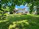 Spacious backyard featuring a wooden deck and lush green lawn with plenty of space for outdoor activities at 4536 Clayburn Dr, Indianapolis, IN 46268