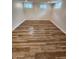 Finished basement with three windows and hard surface floors with neutral paint and trim at 4536 Clayburn Dr, Indianapolis, IN 46268