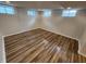 Finished basement with lots of light from multiple windows and hard surface floors with neutral paint and trim at 4536 Clayburn Dr, Indianapolis, IN 46268