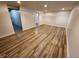 Finished basement area with hard surface floors, neutral paint and trim, and access to another room at 4536 Clayburn Dr, Indianapolis, IN 46268