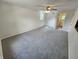 Spacious bedroom with neutral tones, a ceiling fan, and plush carpeting, providing a cozy and versatile living space at 4536 Clayburn Dr, Indianapolis, IN 46268