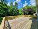 Spacious wooden deck with railings offers a great space for outdoor entertaining with a beautiful tree-lined yard at 4536 Clayburn Dr, Indianapolis, IN 46268