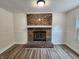 Living room with brick fireplace featuring modern floors, freshly painted walls, and molding for an inviting ambiance at 4536 Clayburn Dr, Indianapolis, IN 46268