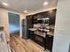 This modern kitchen offers stainless steel appliances, dark cabinetry and wood-look flooring, ready for meal preparation at 4536 Clayburn Dr, Indianapolis, IN 46268