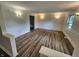 The freshly painted living room has wood-look floors, updated lighting, and decorative molding creating a move-in ready space at 4536 Clayburn Dr, Indianapolis, IN 46268