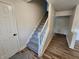 Carpeted staircase with white railing leads to upper level, enhancing the home's interior with comfort and style at 4536 Clayburn Dr, Indianapolis, IN 46268