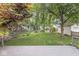 Private backyard showcasing a nice deck, playset, a garage, and mature landscaping at 5315 Rosslyn Ave, Indianapolis, IN 46220