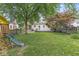 Expansive backyard features mature trees, a wood fence, and a deck that is great for entertaining at 5315 Rosslyn Ave, Indianapolis, IN 46220
