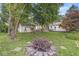 Private backyard oasis with a play set, mature trees, a fire pit, and a detached garage at 5315 Rosslyn Ave, Indianapolis, IN 46220