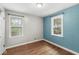 Bedroom with natural light, hardwood floors and freshly painted walls at 5315 Rosslyn Ave, Indianapolis, IN 46220