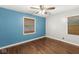 Bedroom featuring a ceiling fan, hardwood floors, and a sun-blocking shade at 5315 Rosslyn Ave, Indianapolis, IN 46220