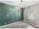 Well-lit dining area featuring vinyl floors, a modern light fixture, and gray trim at 5315 Rosslyn Ave, Indianapolis, IN 46220