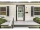 Close-up of the inviting front porch with a dark trim and gray painted steps and porch at 5315 Rosslyn Ave, Indianapolis, IN 46220