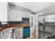 Open kitchen featuring stainless steel appliances, white cabinets, and a dishwasher at 5315 Rosslyn Ave, Indianapolis, IN 46220