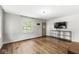 Inviting living room featuring hardwood floors, a large window, and neutral wall paint at 5315 Rosslyn Ave, Indianapolis, IN 46220