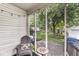 Cozy screened porch with a patio and outdoor chair, perfect for enjoying the serene backyard view at 5315 Rosslyn Ave, Indianapolis, IN 46220