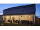Cozy backyard patio with string lights, dining set, lounge seating, and views of the home's exterior at 5353 Hibiscus Dr, Plainfield, IN 46168