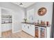 The cozy bar area is complete with custom cabinets, a wine fridge and stylish decor at 5353 Hibiscus Dr, Plainfield, IN 46168