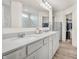 Bright bathroom with double sink vanity, marble countertops, modern fixtures, and walk-in closets at 5353 Hibiscus Dr, Plainfield, IN 46168