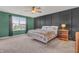 Serene bedroom featuring a modern accent wall, comfortable bedding, and natural light from a nearby window at 5353 Hibiscus Dr, Plainfield, IN 46168