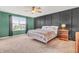 Modern bedroom featuring stylish accent wall, neutral carpet and a comfortable, well-lit space with a ceiling fan at 5353 Hibiscus Dr, Plainfield, IN 46168