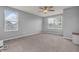 Spacious bonus room with neutral walls, plush carpeting, two large windows, and a ceiling fan at 5353 Hibiscus Dr, Plainfield, IN 46168