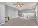 Open-concept bonus room with plush carpeting, neutral walls, a pendant light, and a ceiling fan at 5353 Hibiscus Dr, Plainfield, IN 46168
