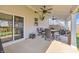 Covered patio with ceiling fans, dining table and chairs, perfect for outdoor entertaining at 5353 Hibiscus Dr, Plainfield, IN 46168