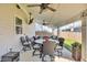 Covered patio featuring ceiling fans, dining table, seating and outdoor television at 5353 Hibiscus Dr, Plainfield, IN 46168