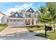 Beautiful two-story home with well-maintained landscaping, inviting front porch, and a charming curb appeal at 5353 Hibiscus Dr, Plainfield, IN 46168
