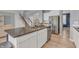 Modern kitchen island featuring granite countertops, a stainless steel dishwasher, and ample cabinet space at 5353 Hibiscus Dr, Plainfield, IN 46168