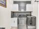 Modern laundry room with new washer/dryer, sleek cabinets, contemporary finishes and designer touches at 5353 Hibiscus Dr, Plainfield, IN 46168