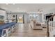 Spacious living room with a kitchen view, stainless steel appliances, and backyard access, perfect for entertaining at 5353 Hibiscus Dr, Plainfield, IN 46168