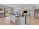 Open-concept kitchen and living room with an island, stainless steel appliances, and access to the backyard at 5353 Hibiscus Dr, Plainfield, IN 46168
