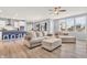 Bright living room with a fireplace, hardwood floors, neutral decor, and large windows at 5353 Hibiscus Dr, Plainfield, IN 46168