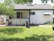 Backyard showcases a covered porch and vibrant green lawn, perfect for outdoor living at , Indianapolis, IN 46218