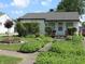 Inviting single-story home with lush landscaping and a stone walkway to the front door at , Indianapolis, IN 46218