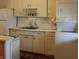 Functional kitchen with white cabinets, laminate countertops, and updated appliances at , Indianapolis, IN 46218