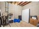 Partially finished basement space with storage shelving, exposed ceiling, and potential for customization at 630 Dorman St, Indianapolis, IN 46202