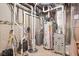 Basement utilities area with water heater, pipes, and various mechanical systems, ensuring functionality at 630 Dorman St, Indianapolis, IN 46202