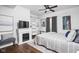 Bright bedroom featuring a fireplace, TV, and a comfortable bed with natural light and neutral decor at 630 Dorman St, Indianapolis, IN 46202