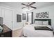 This charming bedroom features neutral walls, a ceiling fan, stylish décor, and a plush bed for a cozy retreat at 630 Dorman St, Indianapolis, IN 46202